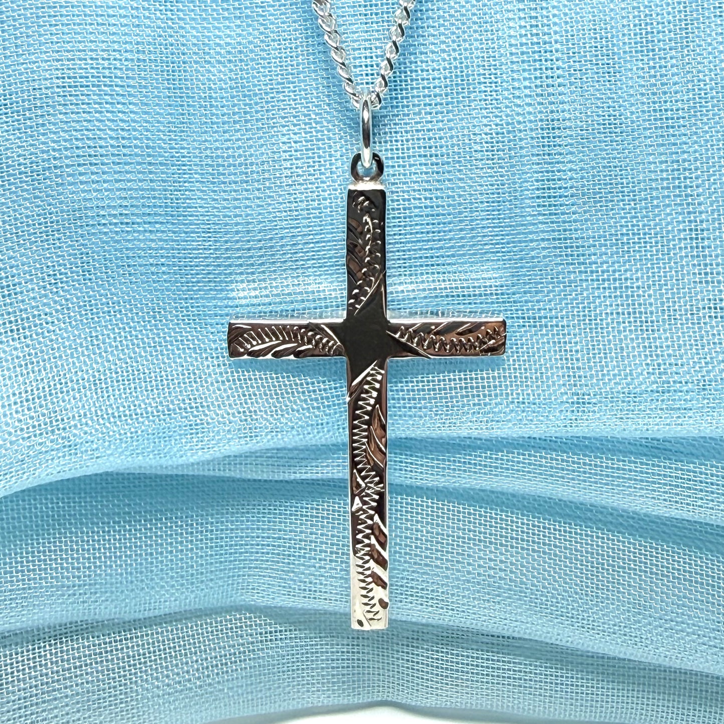 Large cross sterling silver with a patterned design