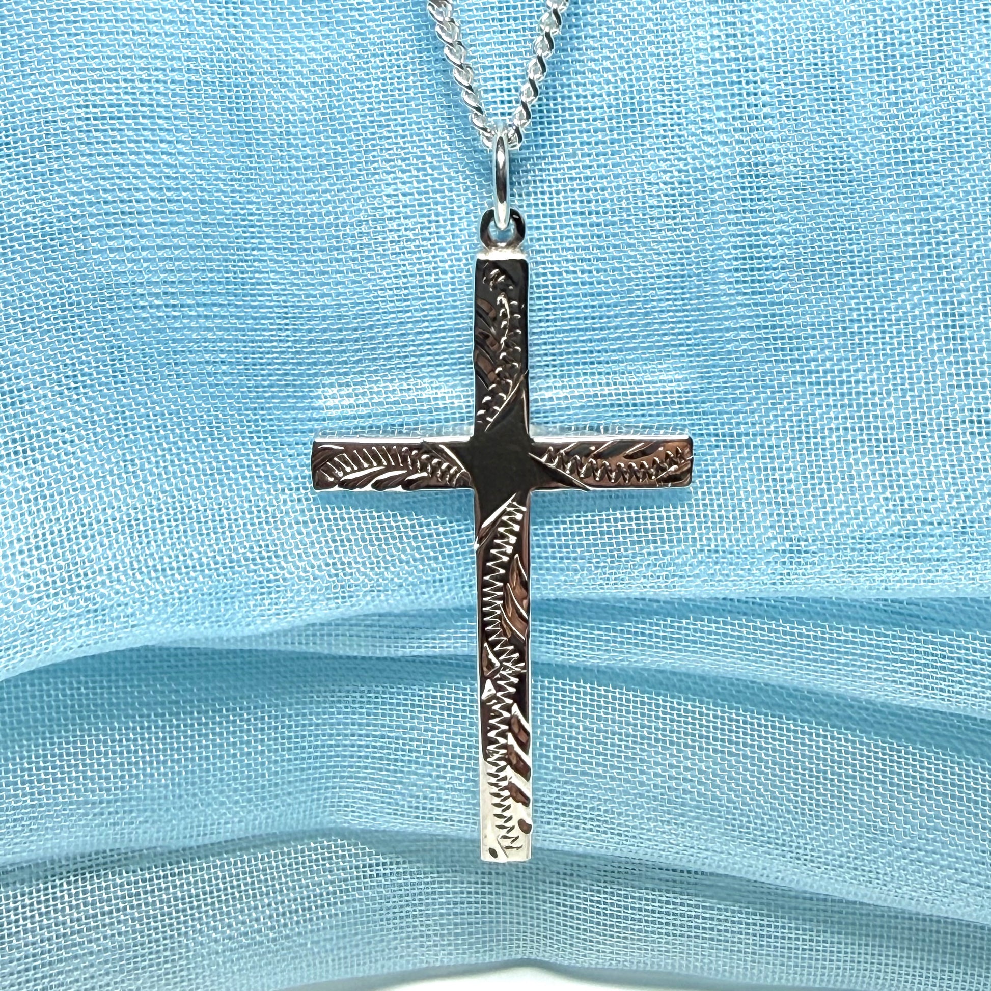 Large cross sterling silver with a patterned design