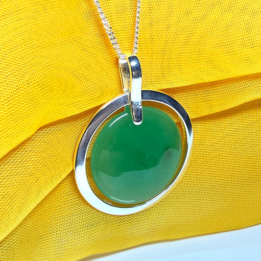 A large round halo necklace sterling silver circle shaped green real jade