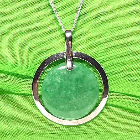 A large sterling silver round shaped green real jade necklace halo style, a traditionally designed pendant