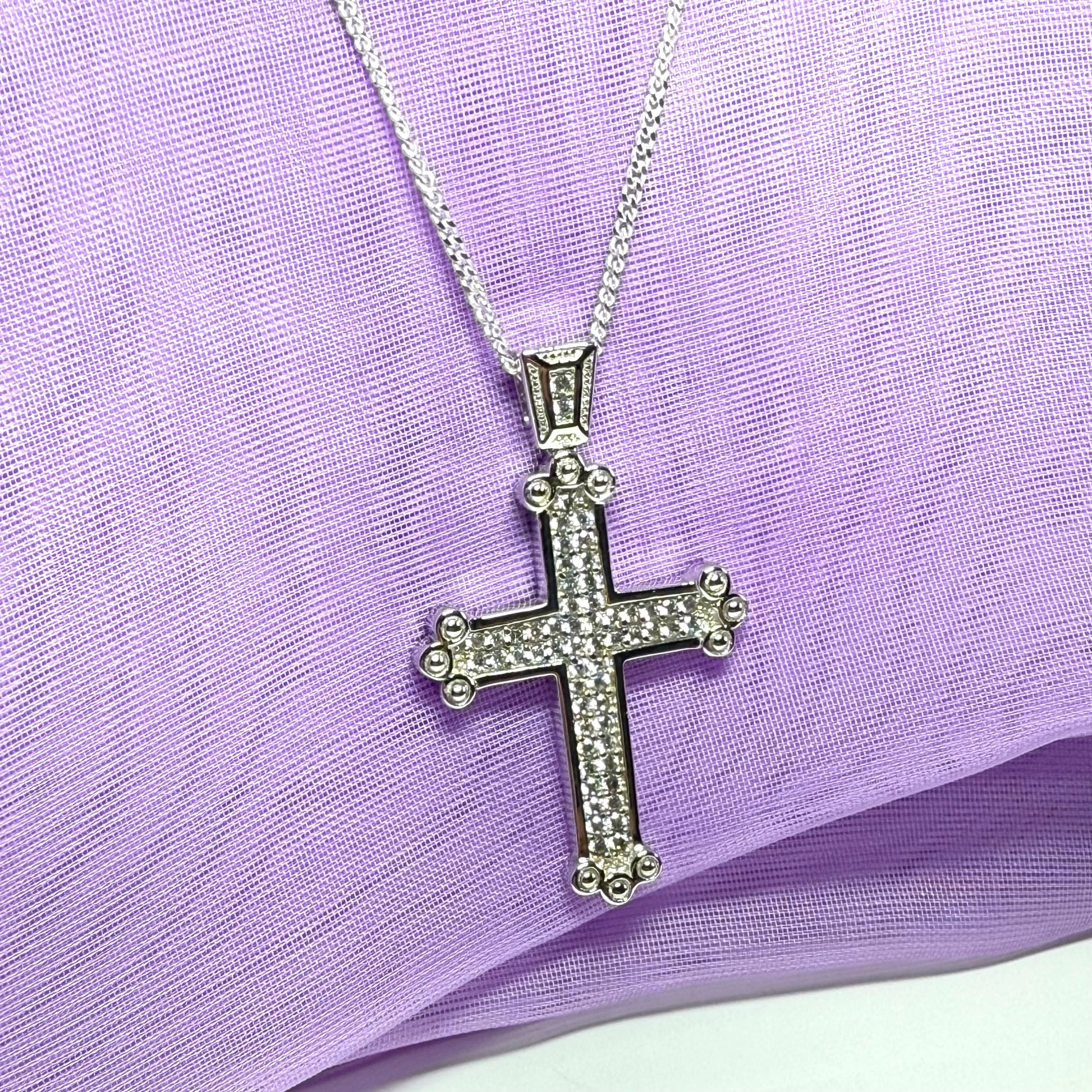 A large stone set cross sterling silver cubic zirconia fancy including chain