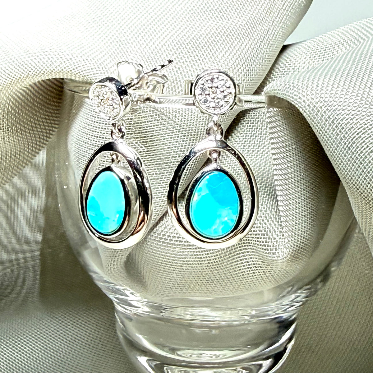 A pair of blue green turquoise oval sterling silver drop earrings double oval