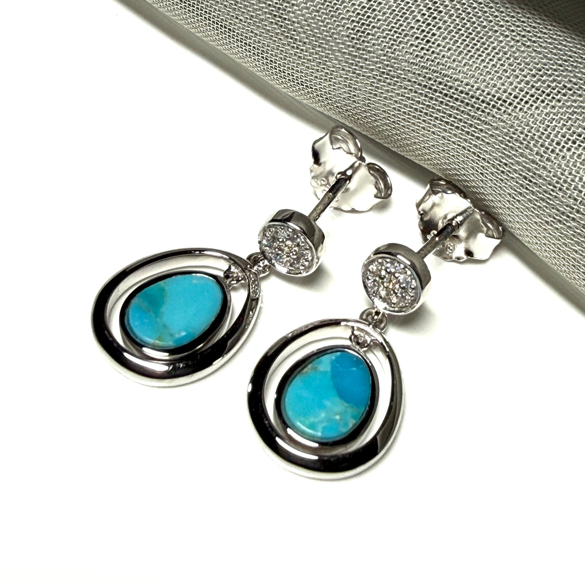 A pair of blue green turquoise oval sterling silver drop earrings double oval