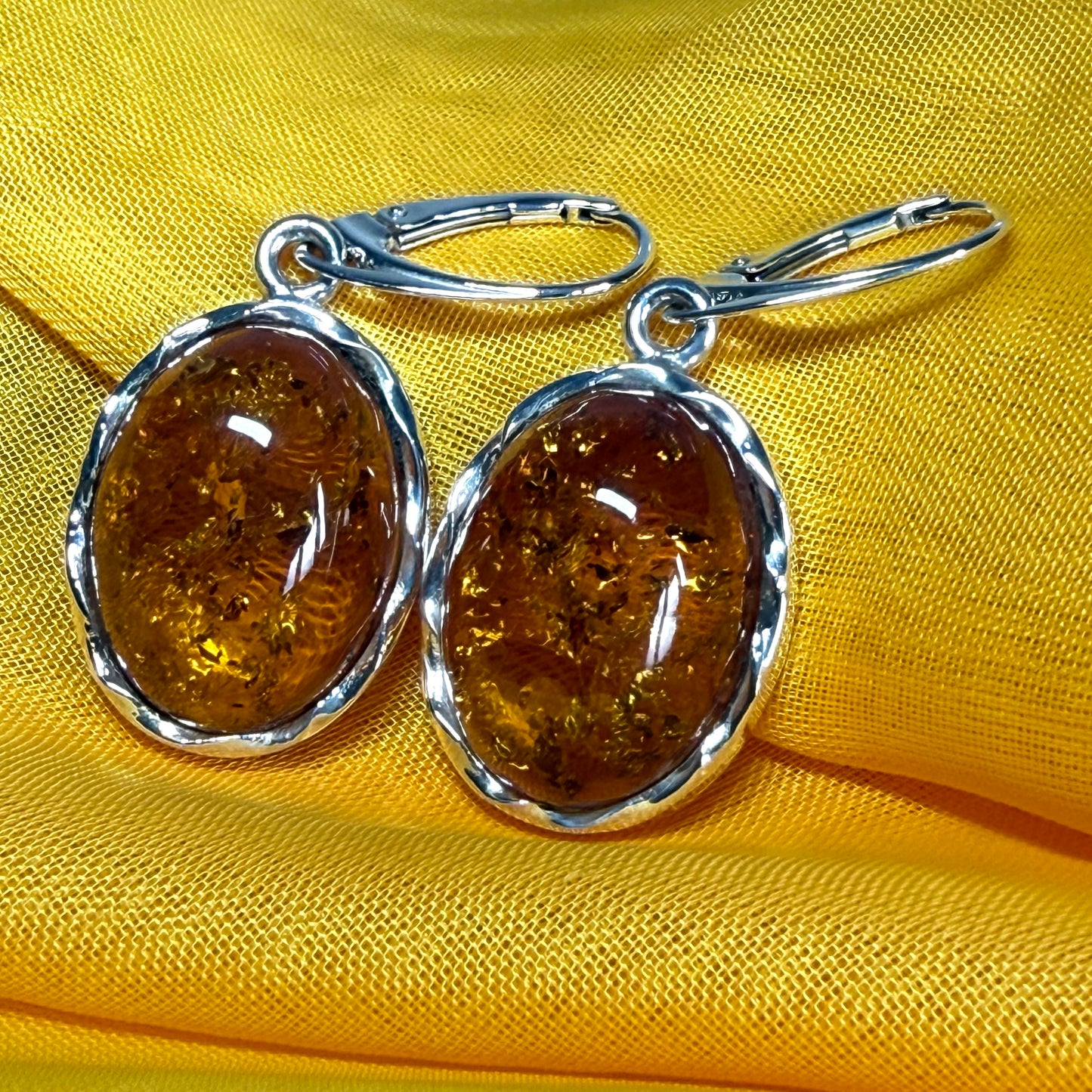 A pair of real amber drop earrings oval in shape sterling silver continental wire fittings