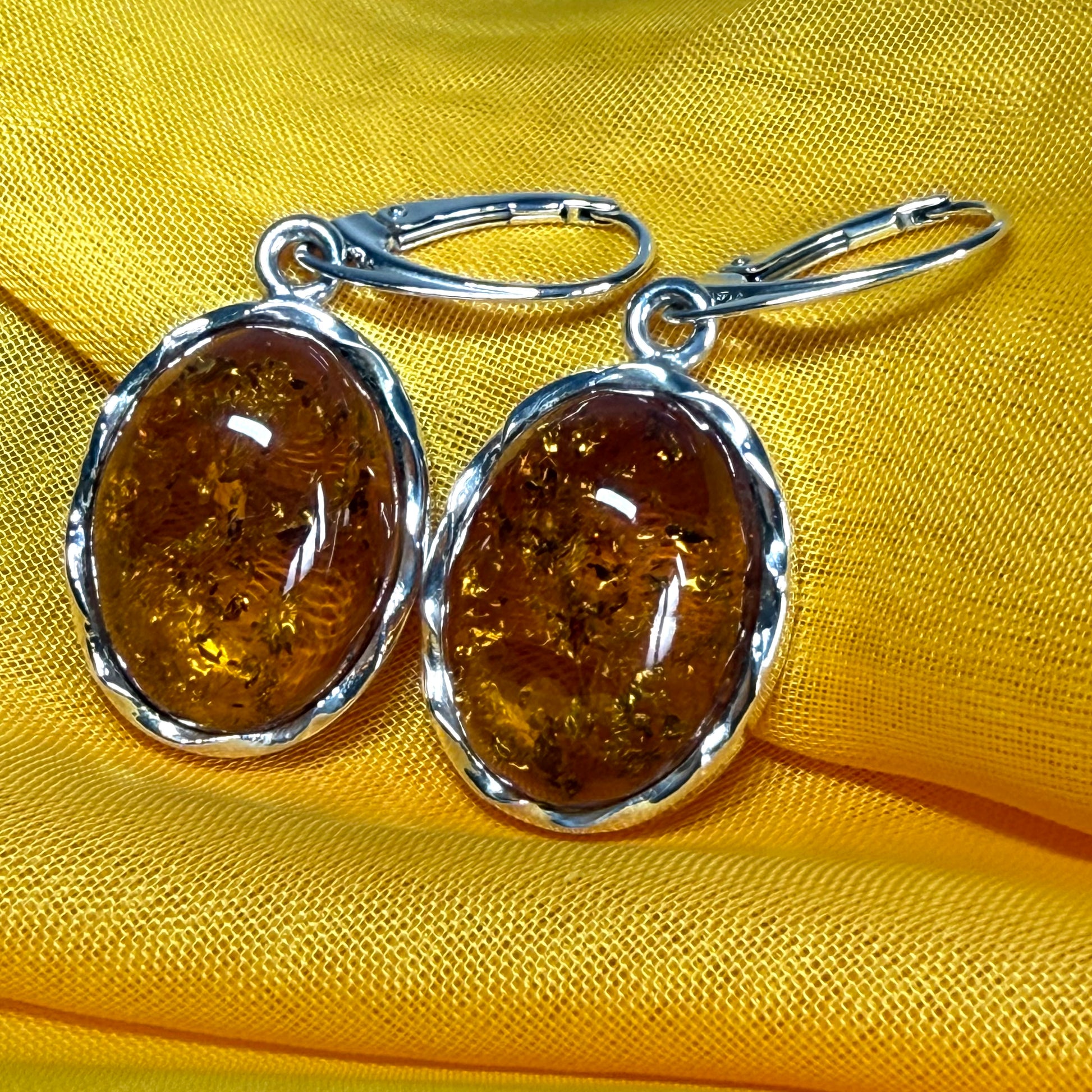 A pair of real amber drop earrings oval in shape sterling silver continental wire fittings