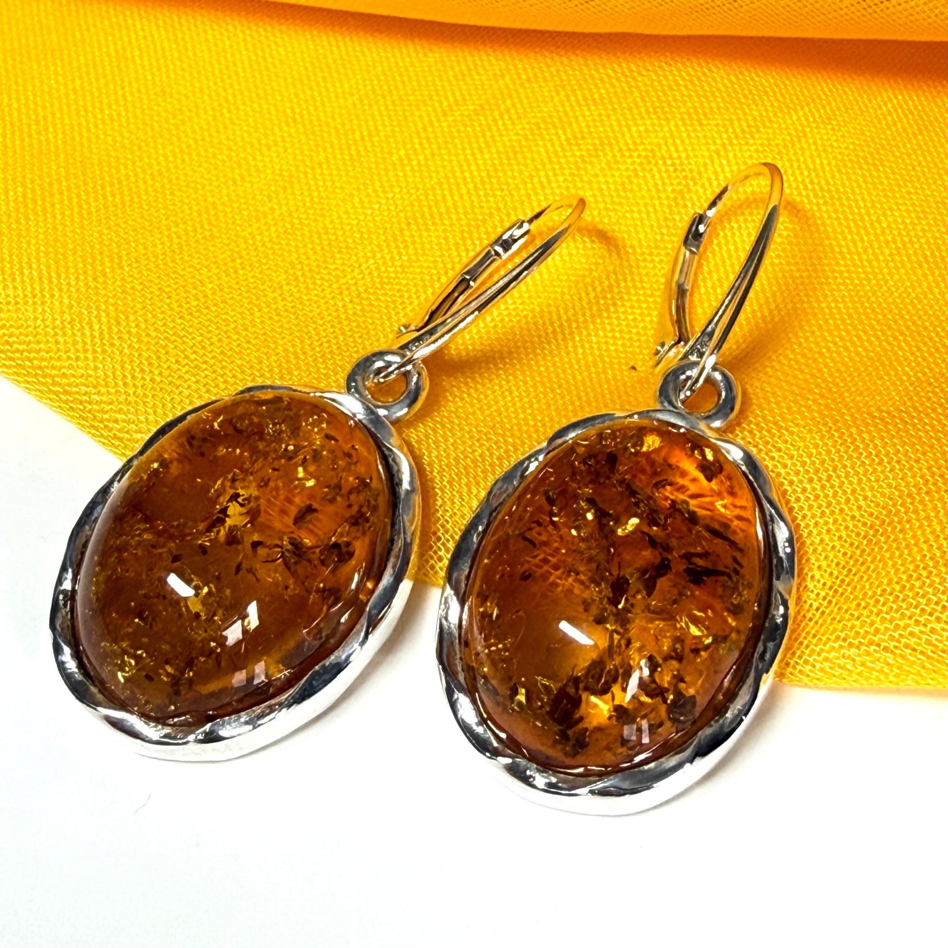 A pair of real amber drop earrings oval in shape sterling silver continental wire fittings
