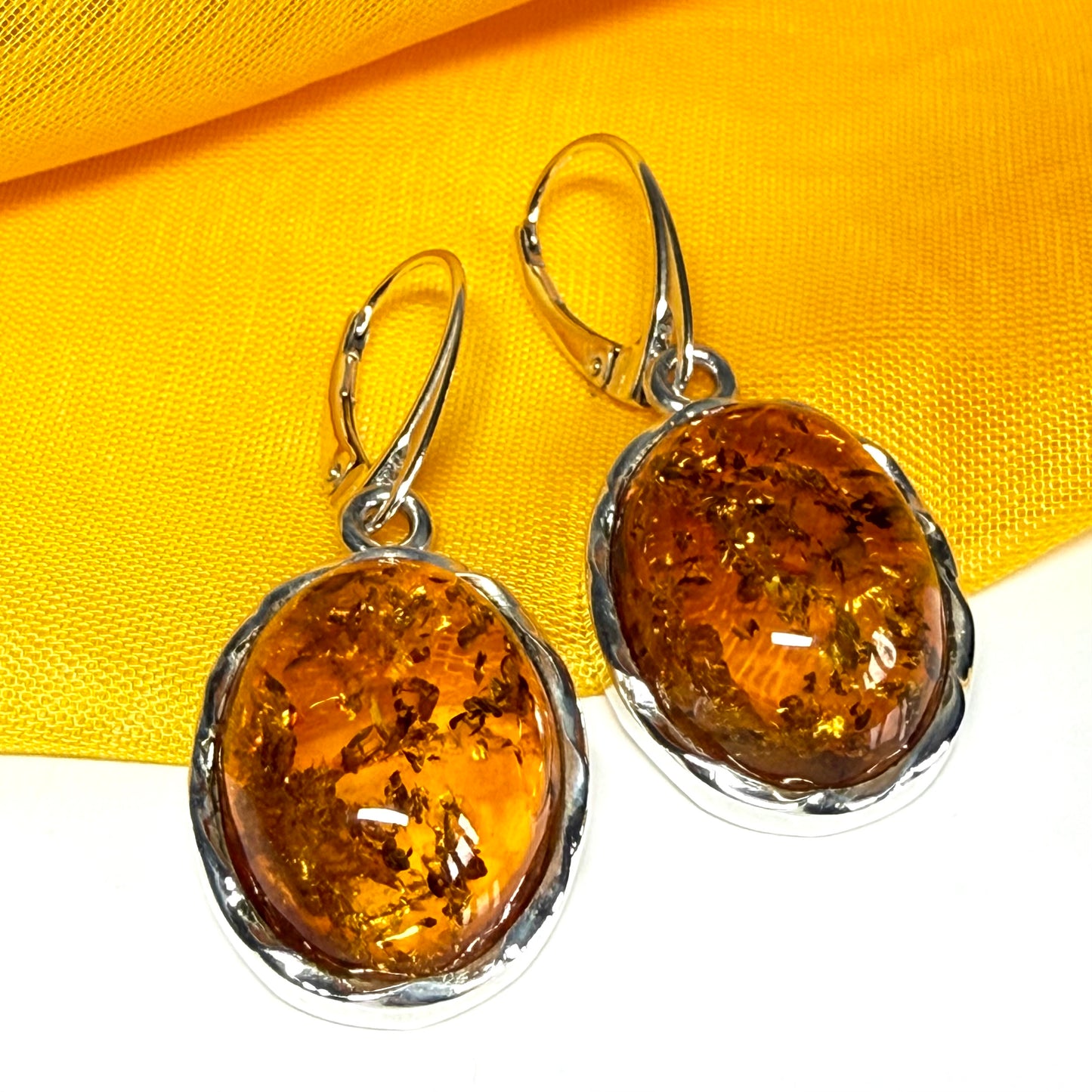 A pair of real amber drop earrings oval in shape sterling silver continental wire fittings