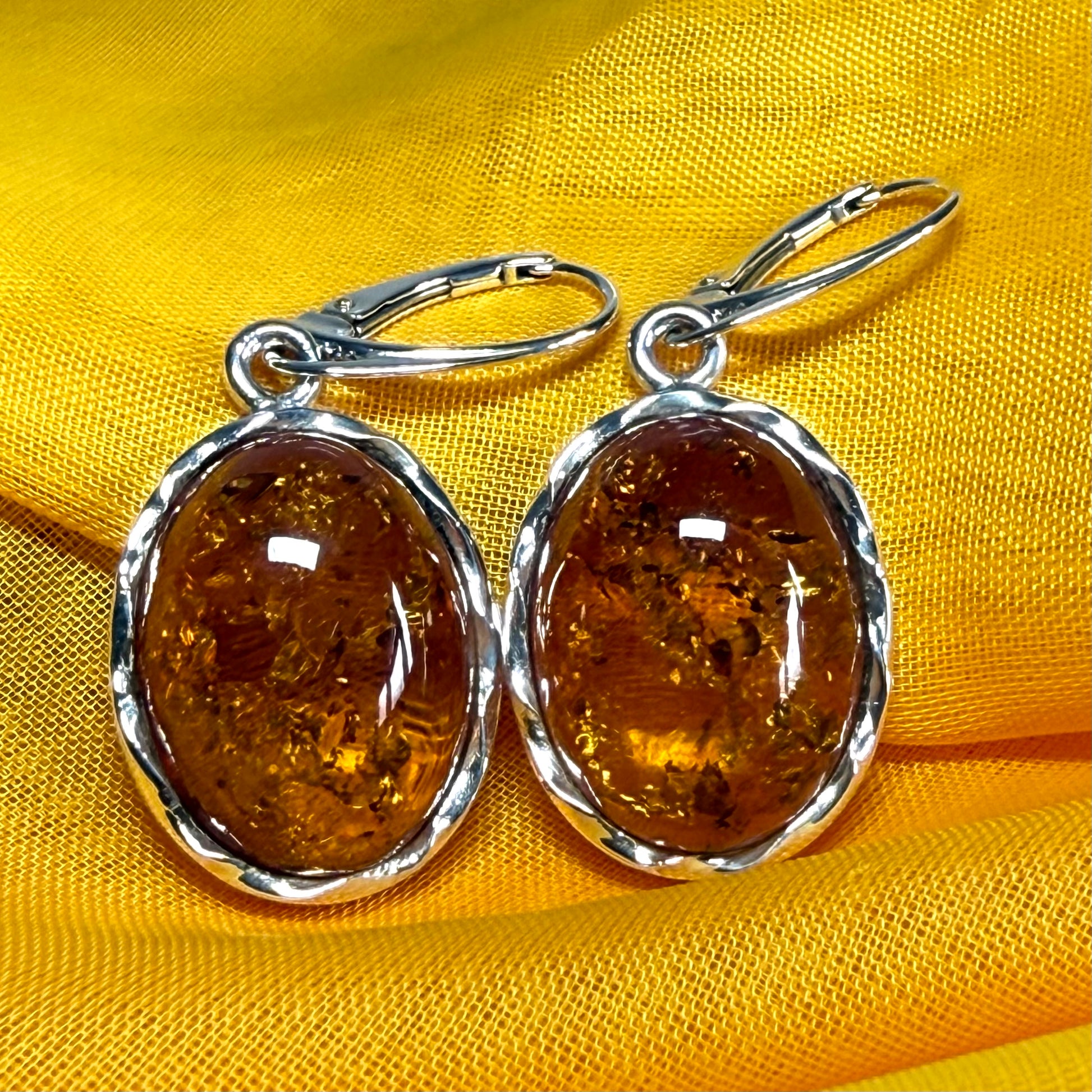 A pair of real amber drop earrings oval in shape sterling silver continental wire fittings