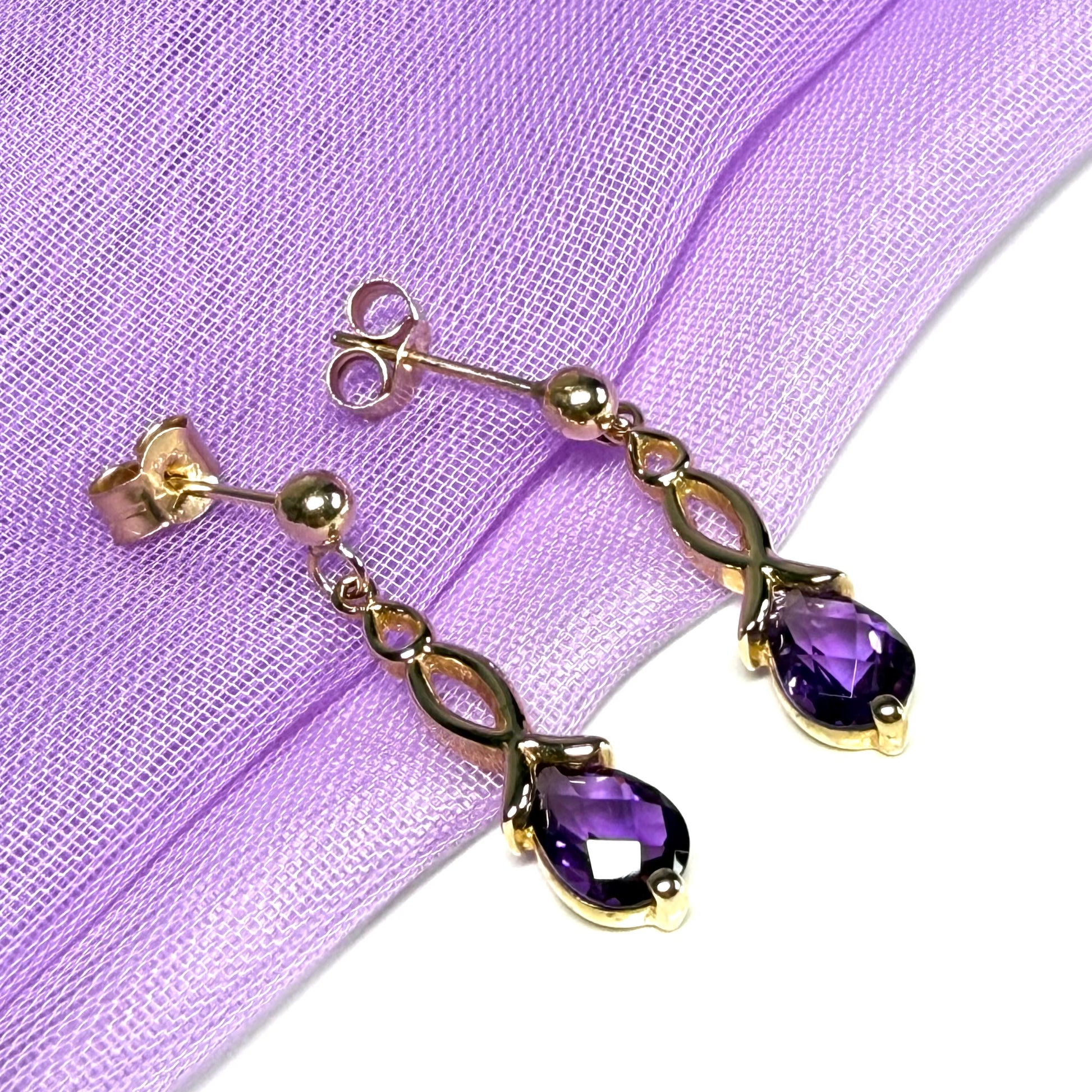 A pair of real amethyst drop earrings pear shaped yellow gold