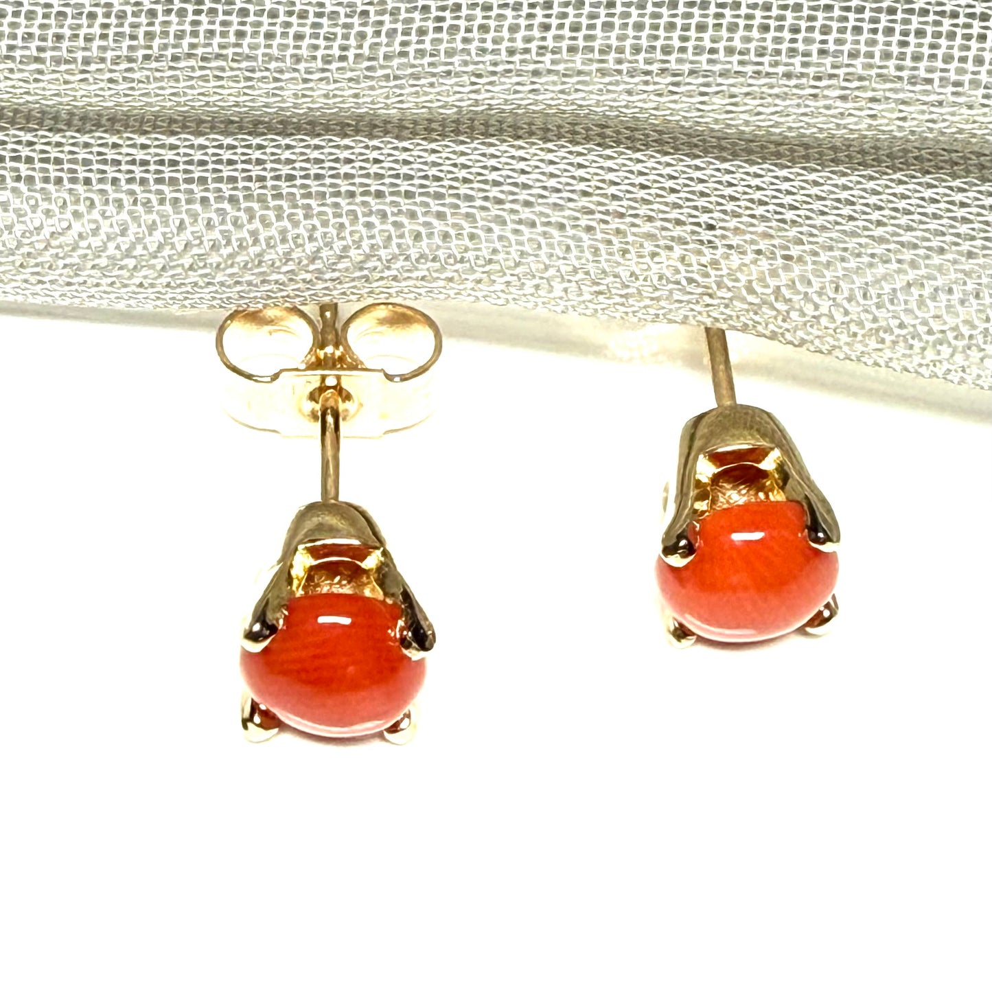 A pair of real dark coral yellow gold round clawed set stud earrings, simply gorgeous