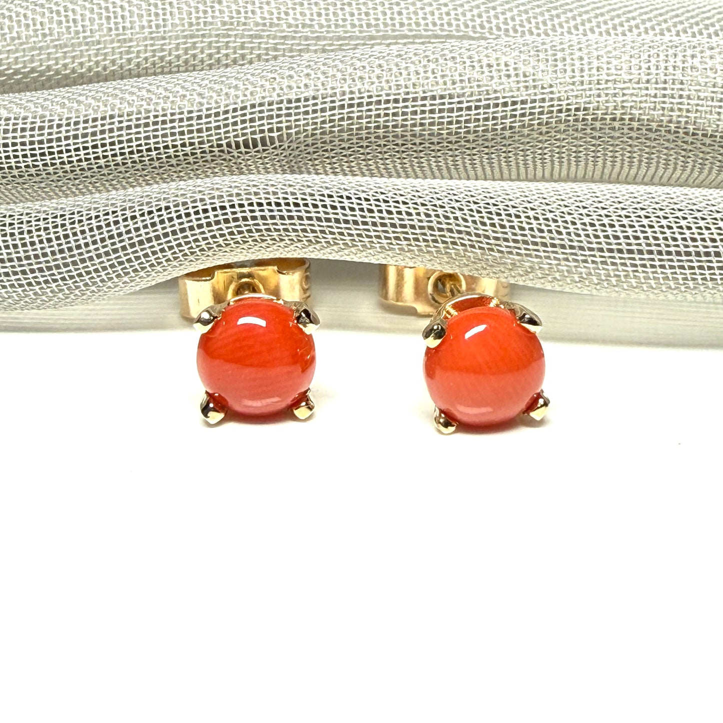 A pair of real dark coral yellow gold round clawed set stud earrings, simply gorgeous