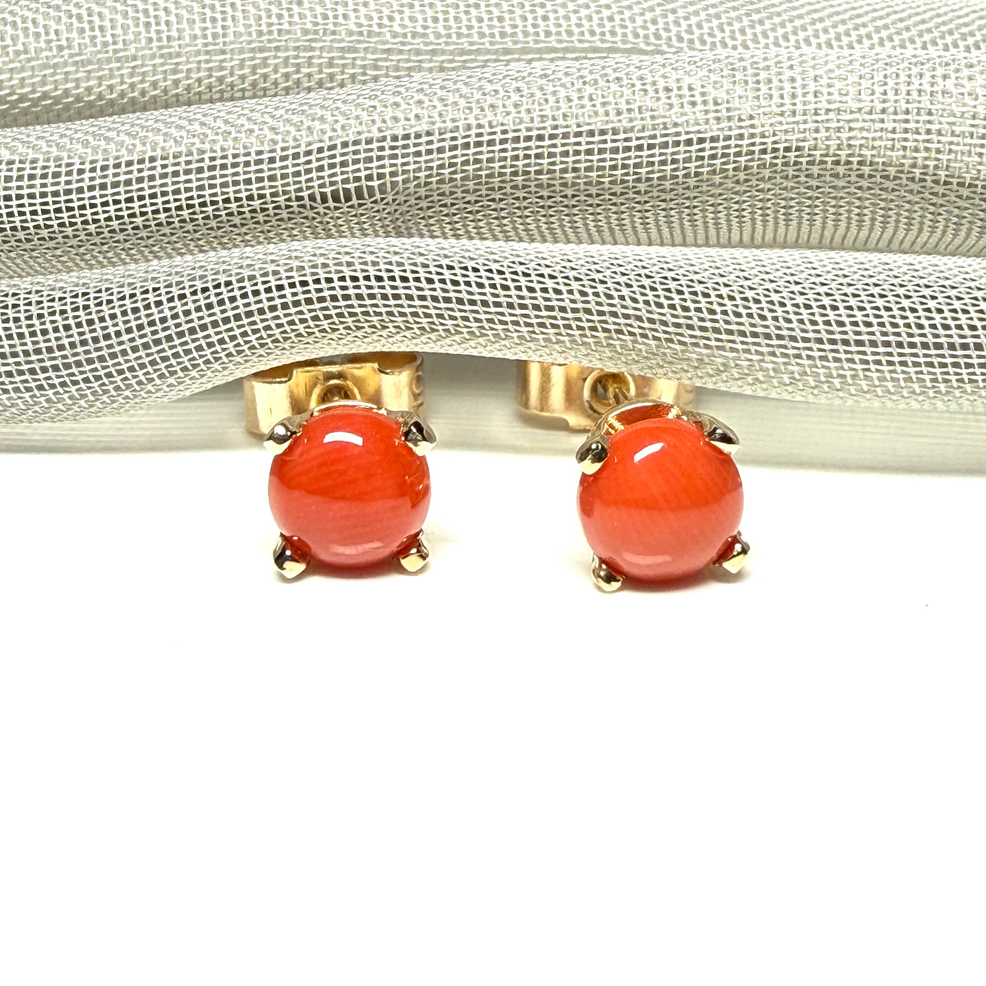 A pair of real dark coral yellow gold round clawed set stud earrings, simply gorgeous