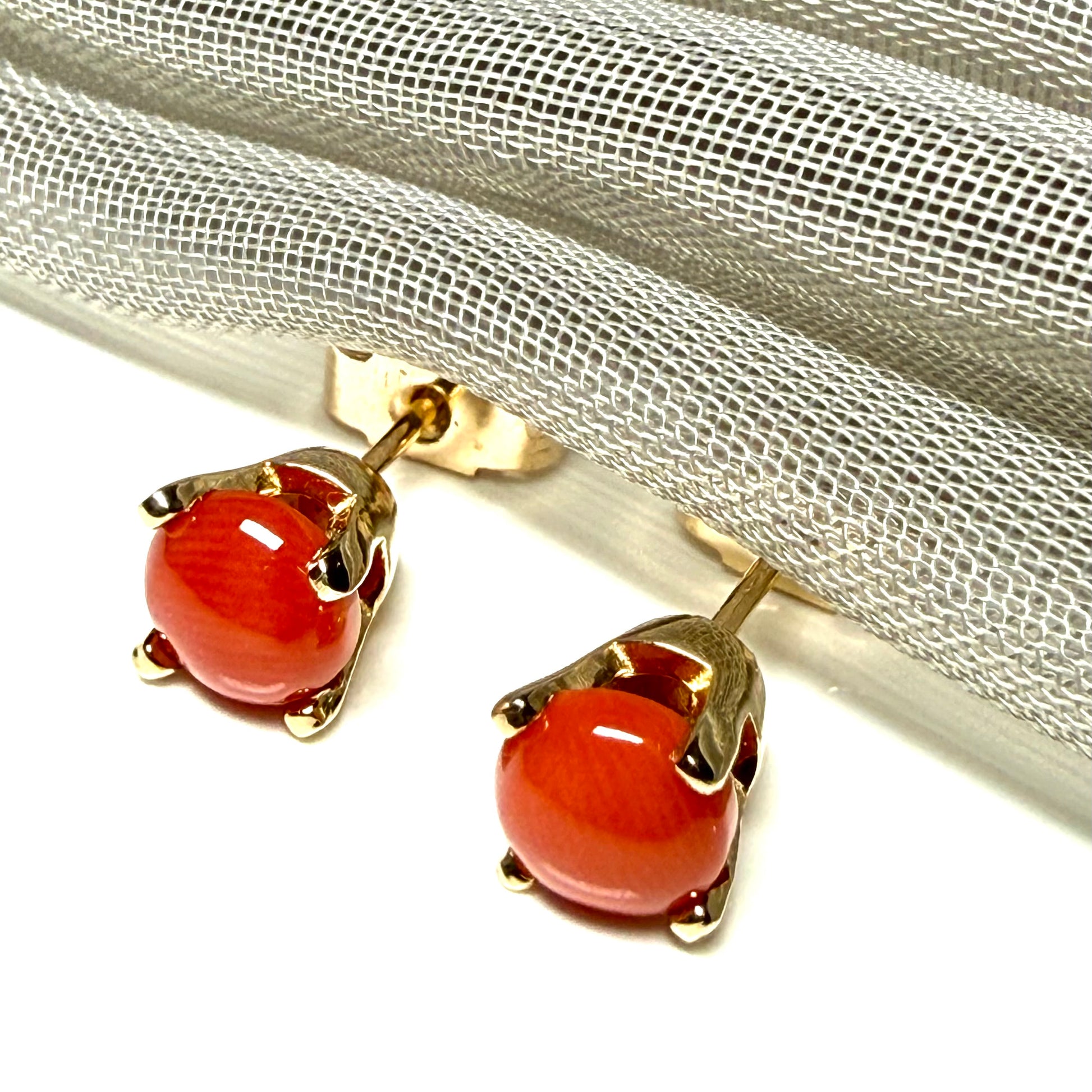 A pair of real dark coral yellow gold round clawed set stud earrings, simply gorgeous