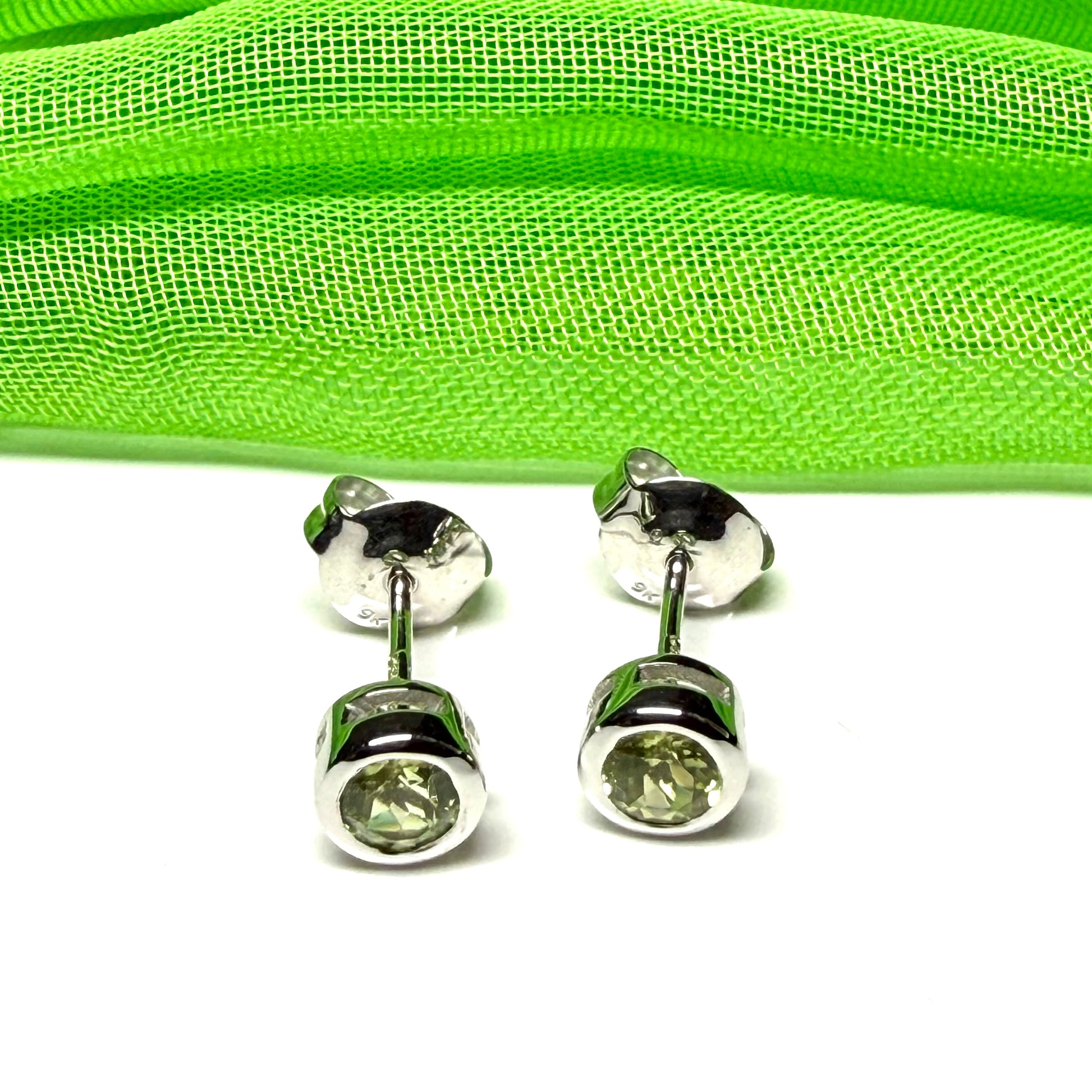 Pair of real green peridot earrings round white gold stud smooth rubbed over setting