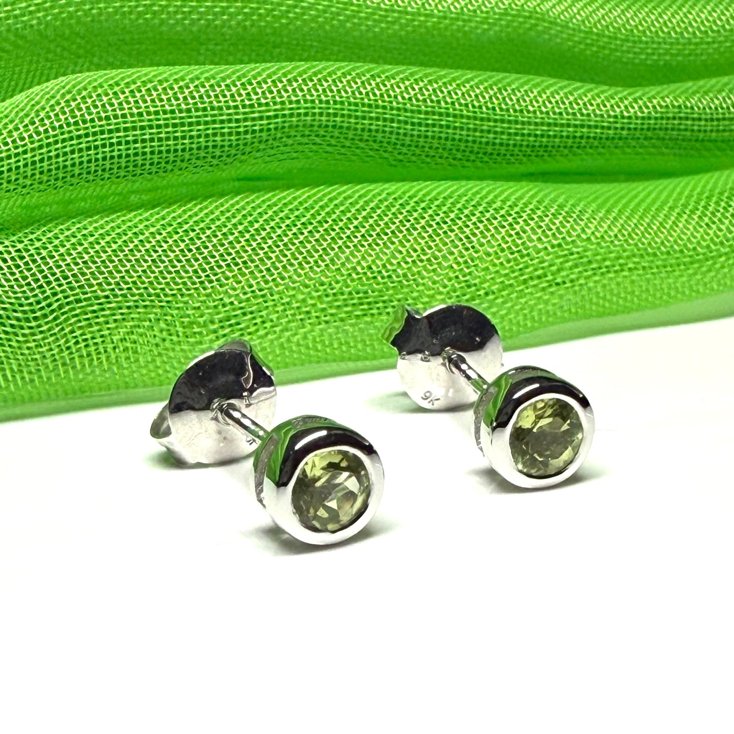 Pair of real green peridot earrings round white gold stud smooth rubbed over setting