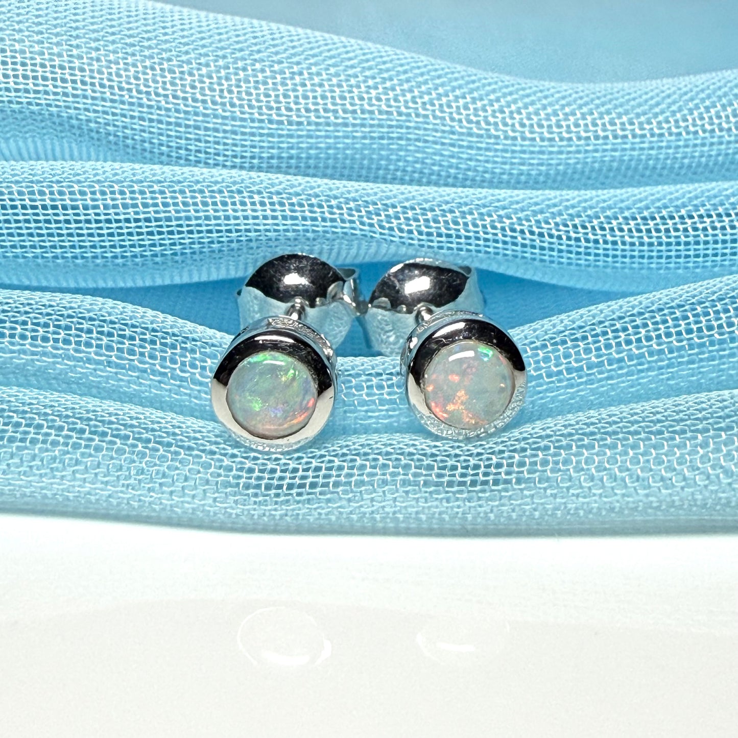 Pair of real opal earrings round white gold stud smooth rubbed over setting