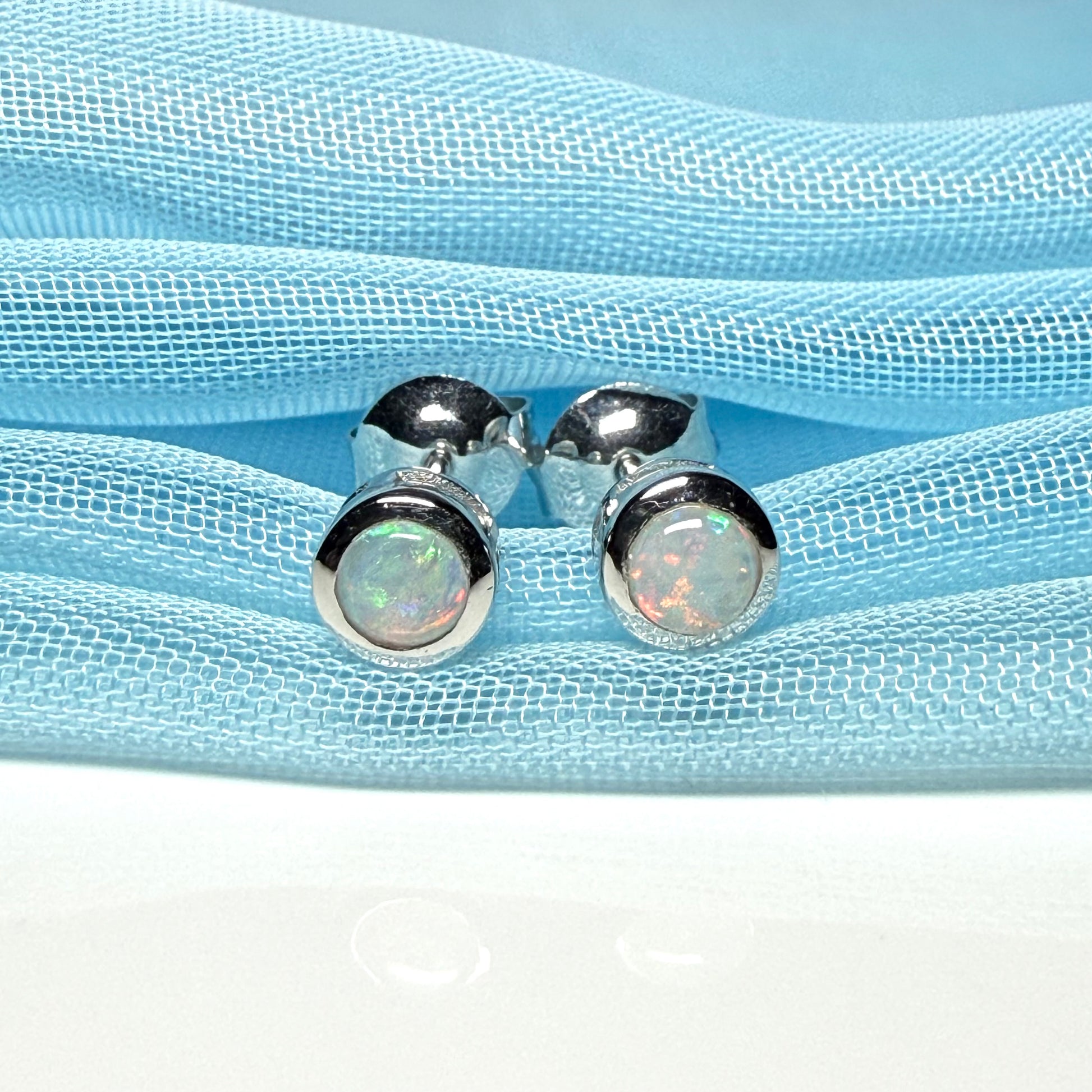 Pair of real opal earrings round white gold stud smooth rubbed over setting