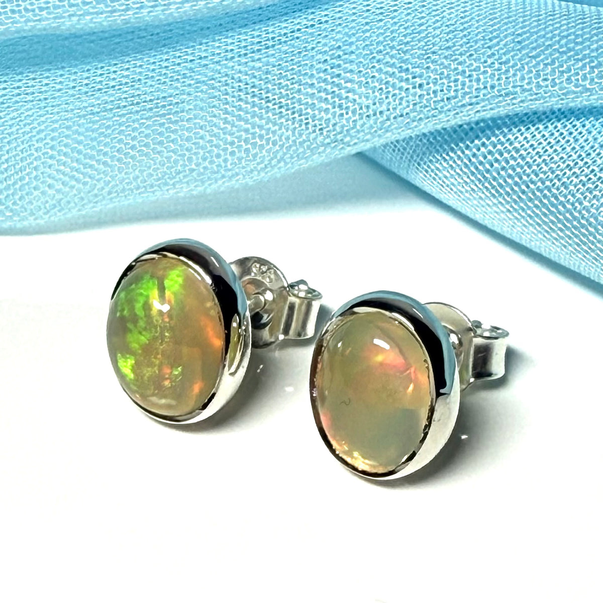 Real opal sterling silver oval shaped stud earrings