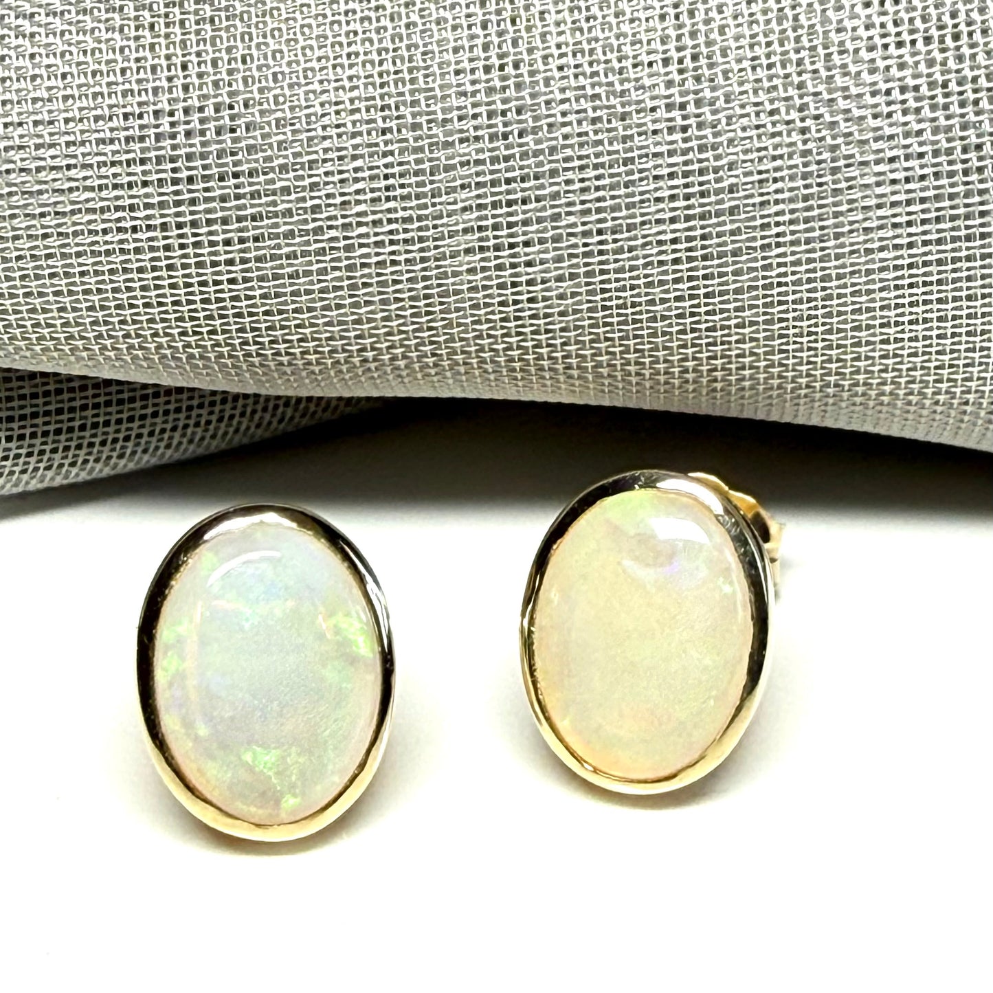 Pair of real opal yellow gold oval stud earrings