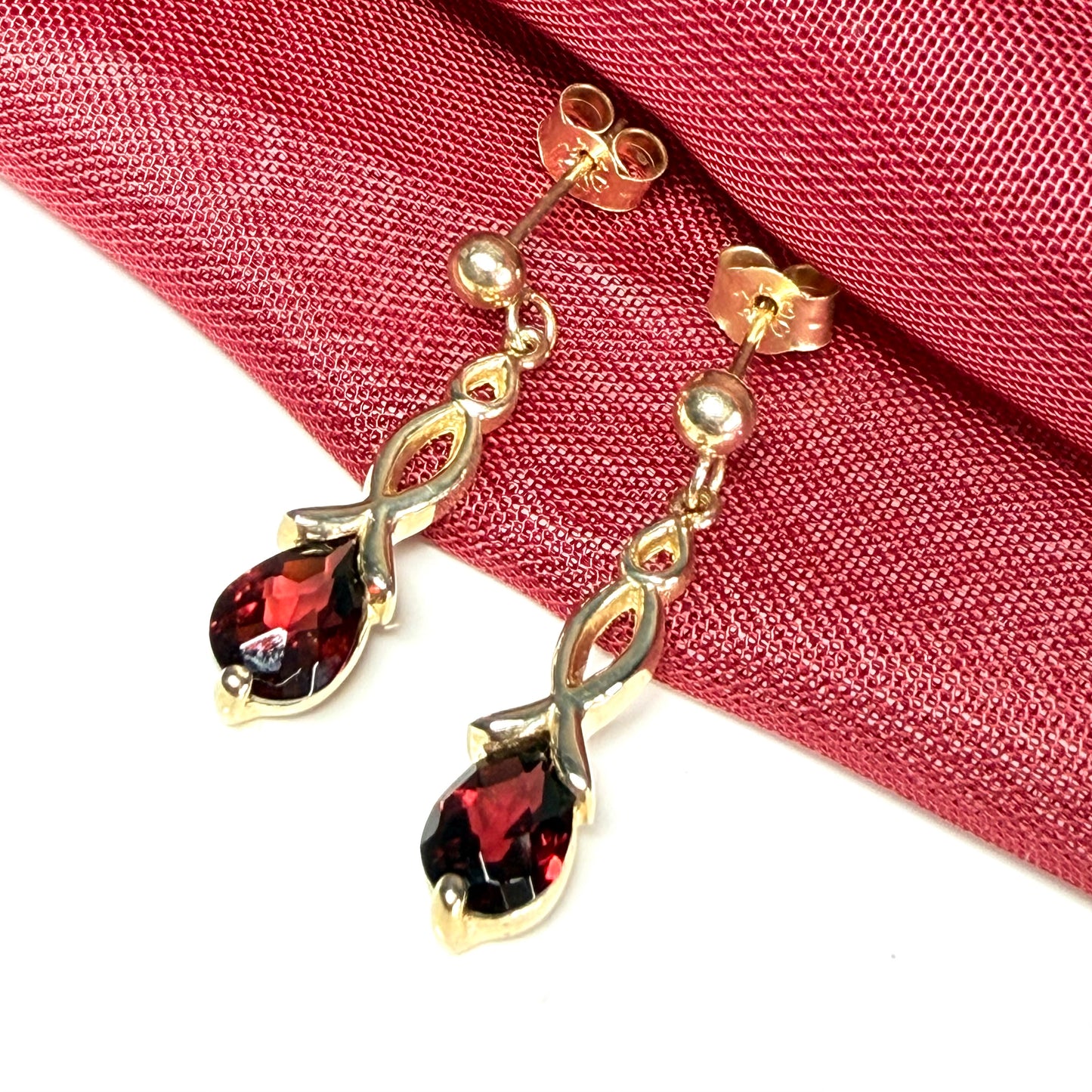 A pair of real red garnet drop earrings pear shaped yellow gold