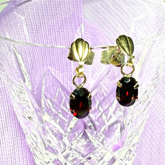 A pair of real red garnet drop earrings oval shaped yellow gold
