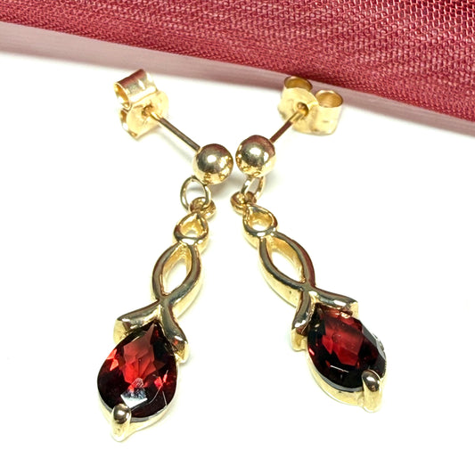 A pair of real red garnet drop earrings pear shaped yellow gold