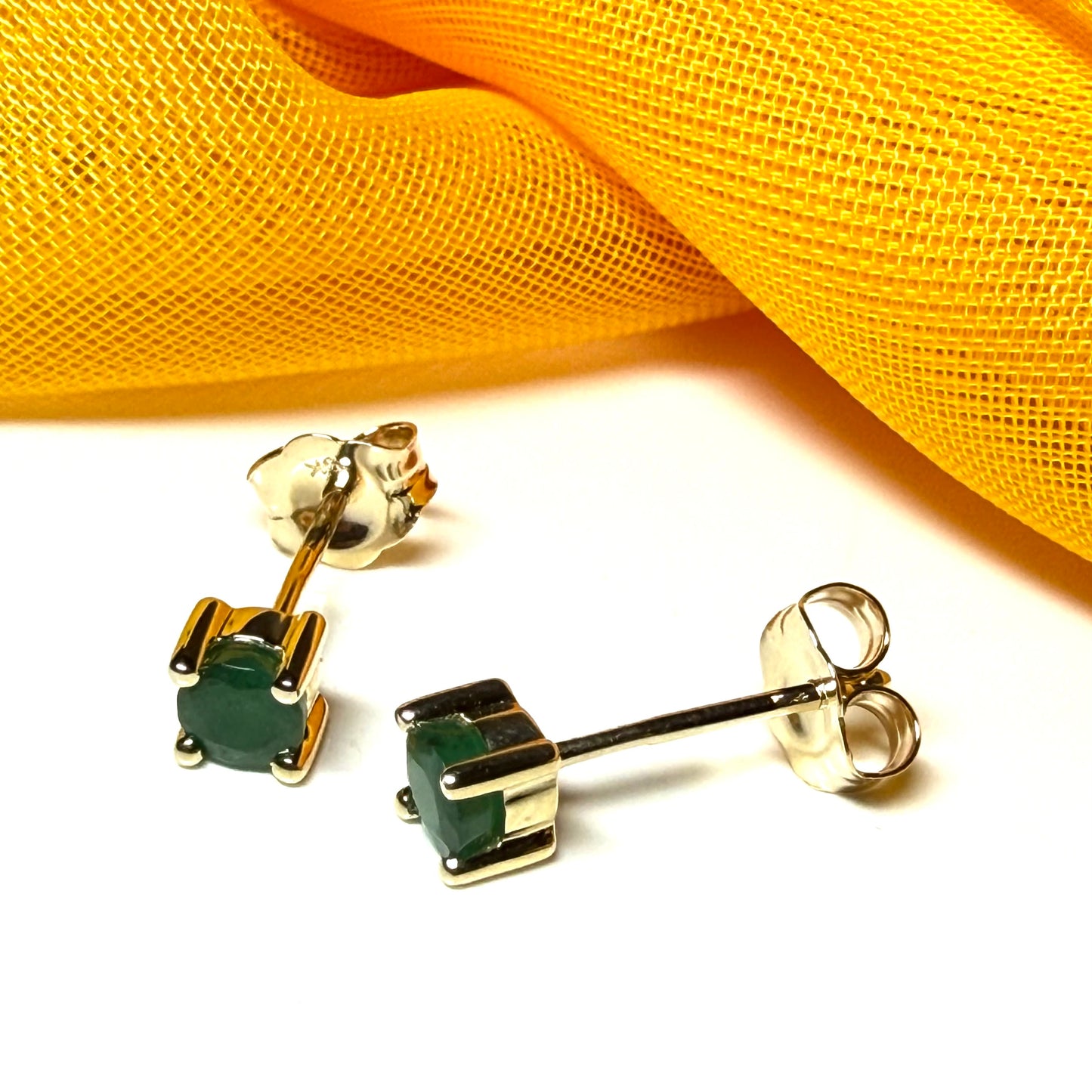 A pair of real ruby earrings round yellow gold claw set studs