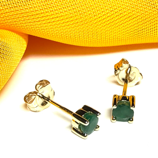 A pair of real ruby earrings round yellow gold claw set studs