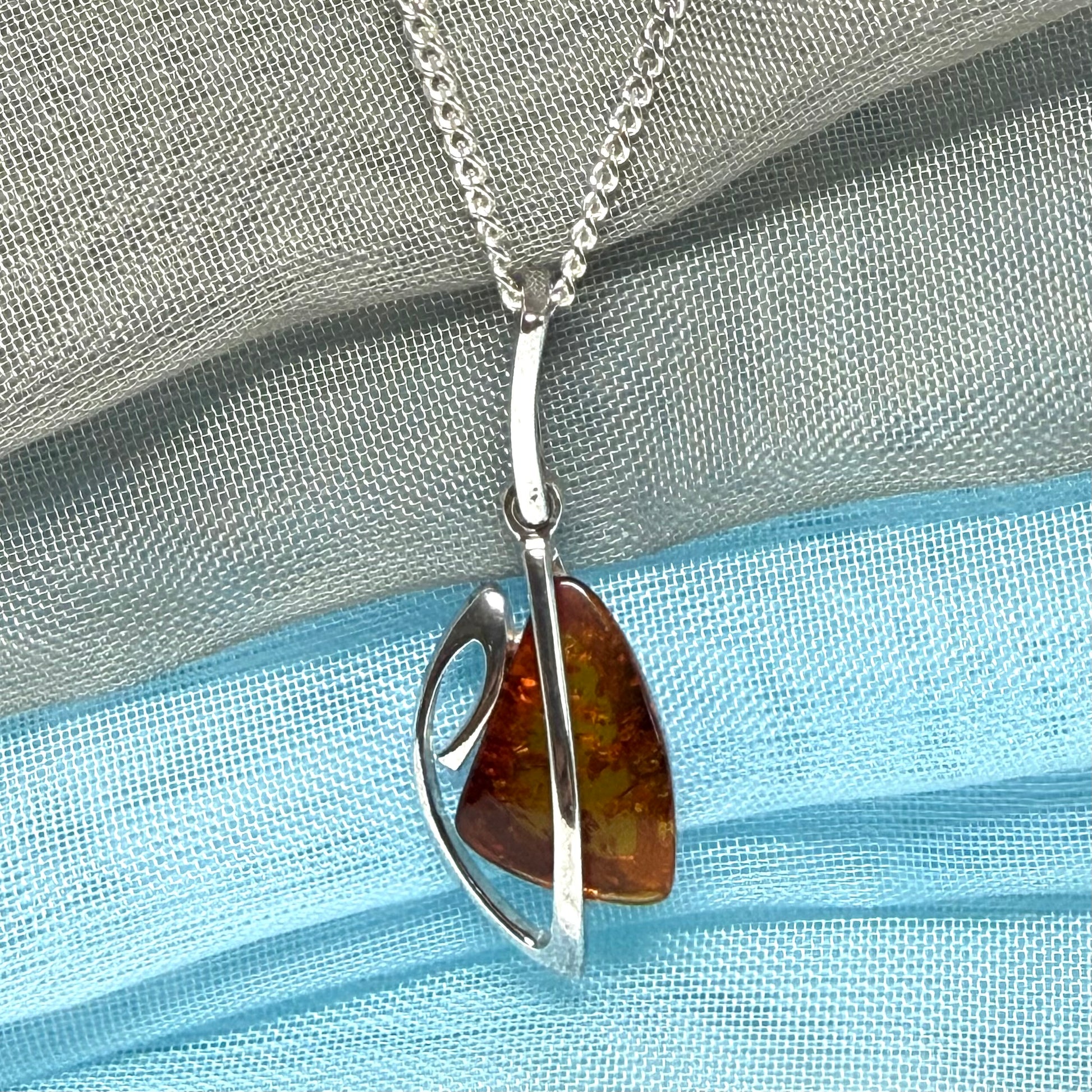 A real amber necklace sterling silver fancy open triangle shaped amber pendant