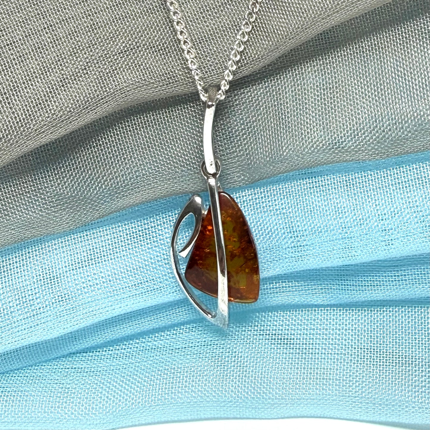 A real amber necklace sterling silver fancy open triangle shaped amber pendant