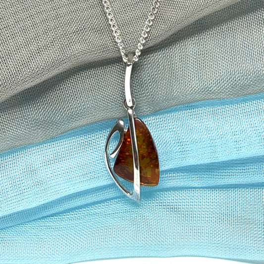 A real amber necklace sterling silver fancy open triangle shaped amber pendant