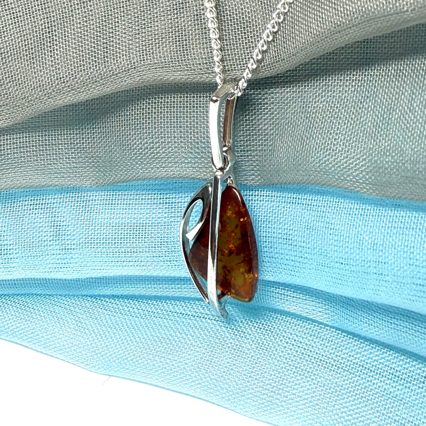 A real amber necklace sterling silver fancy open triangle shaped amber pendant