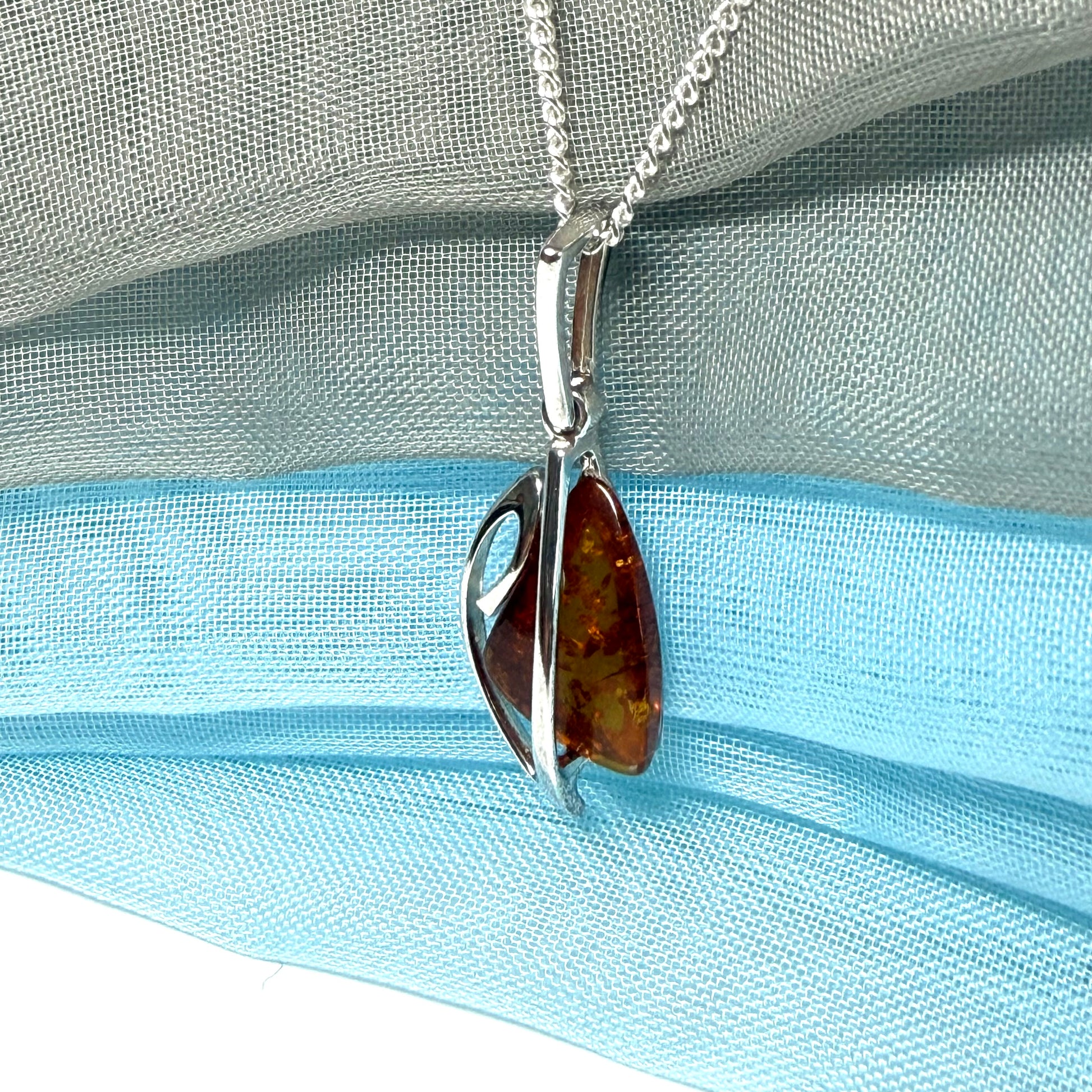 A real amber necklace sterling silver fancy open triangle shaped amber pendant