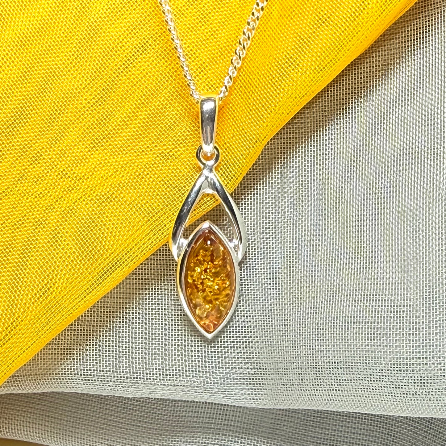 A real amber necklace sterling silver marquise shaped open pendant