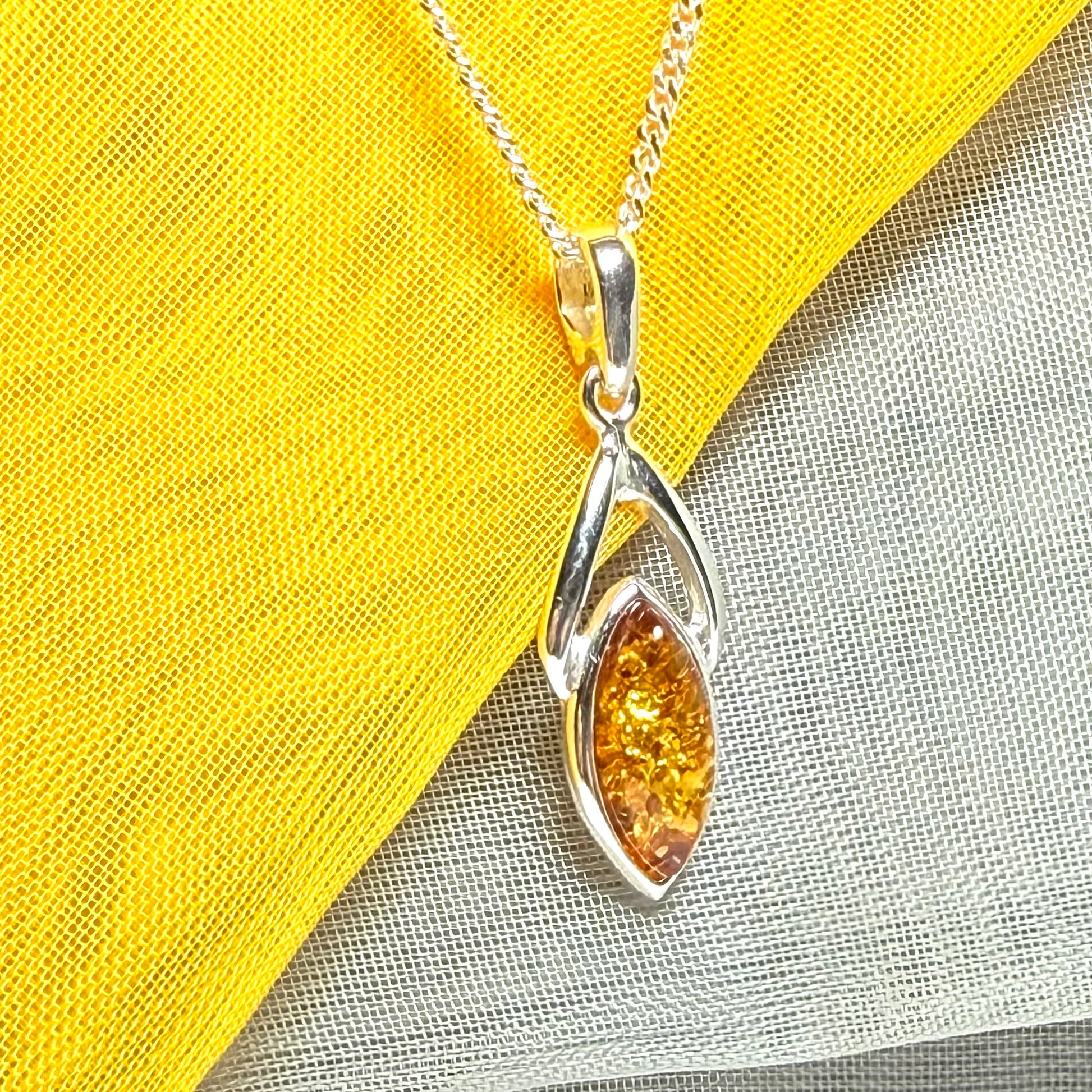 A real amber necklace sterling silver marquise shaped open pendant