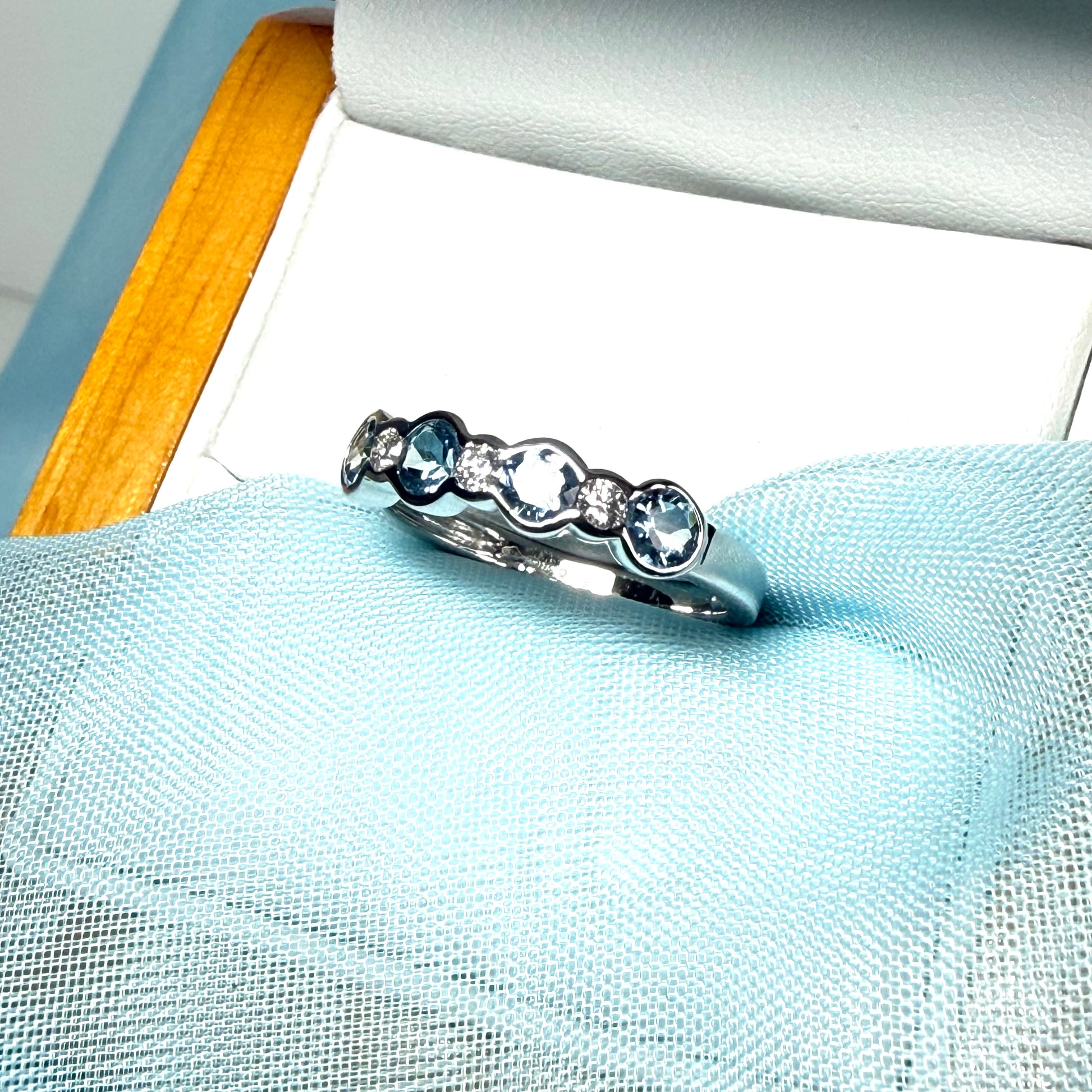 A real aquamarine and diamond white gold eternity ring