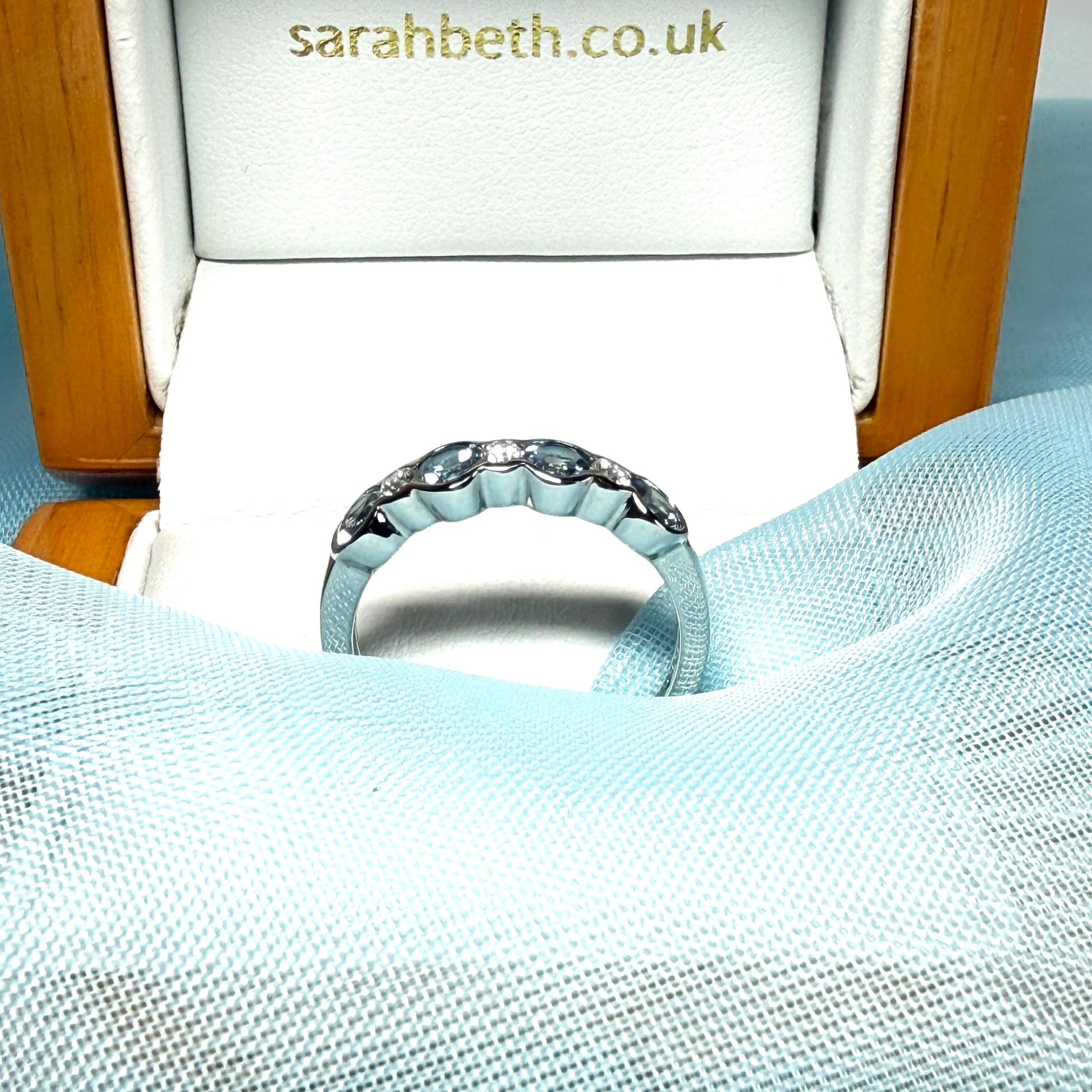 A real aquamarine and diamond white gold eternity ring side view