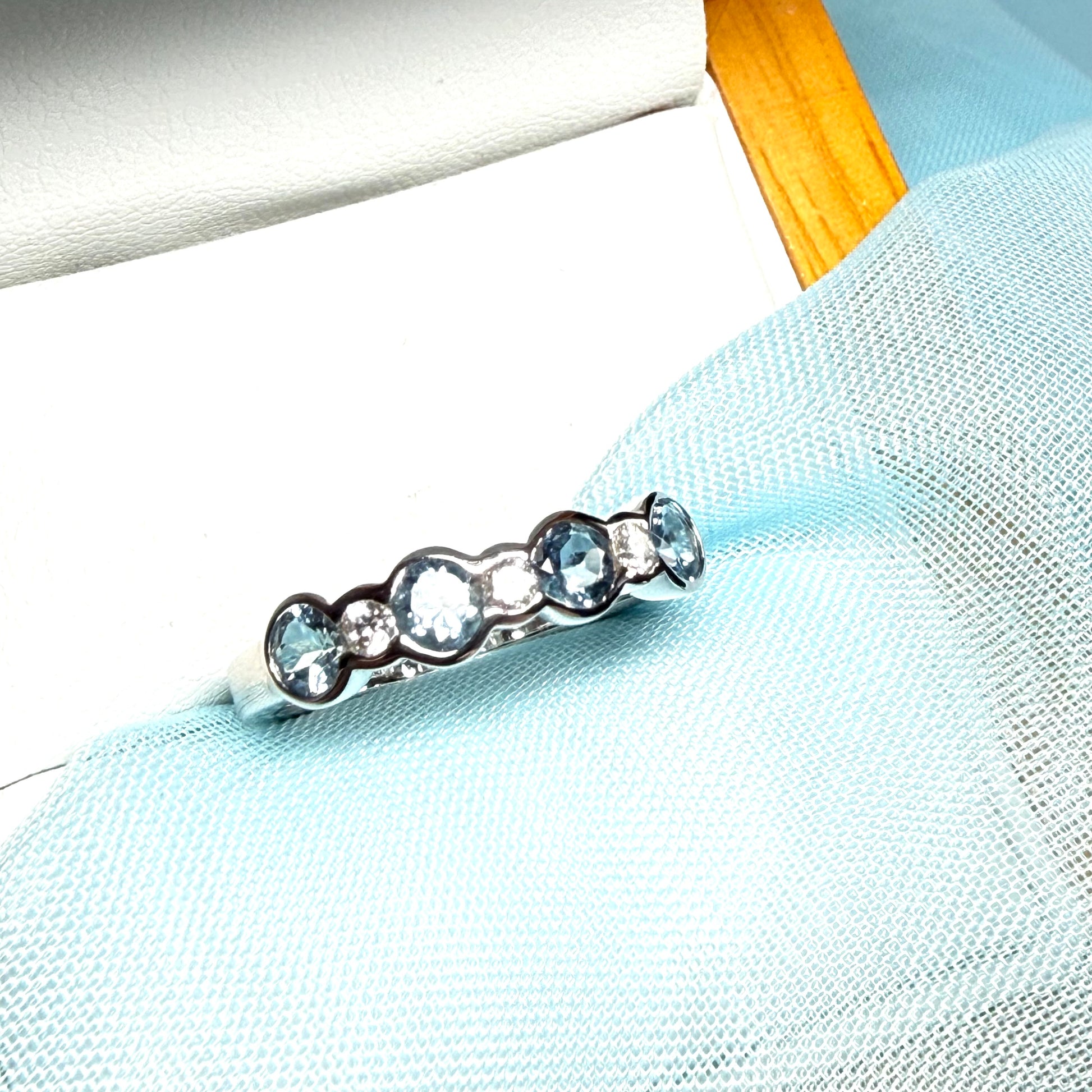 A real aquamarine and diamond white gold eternity ring