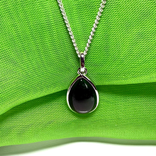 A real dark green jade necklace in a tear drop or pear shape smooth rub over setting