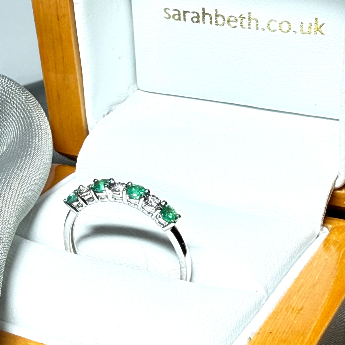 A real emerald and diamond white gold eternity ring claw setting gorgeous