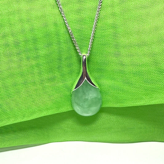 A real green jade necklace having a tear drop or pear shape, a really striking designed pendant with a chain