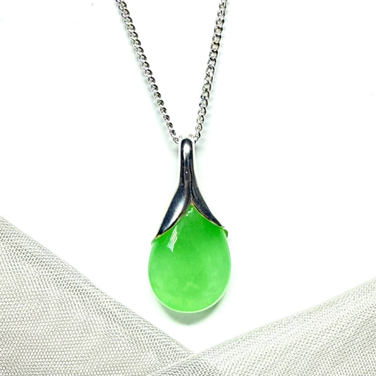 A real green jade necklace having a tear drop or pear shape, a timeless designed pendant