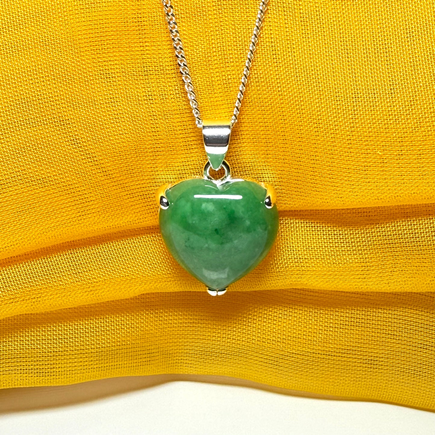 A real green jade necklace heart shape sterling silver pendant including chain