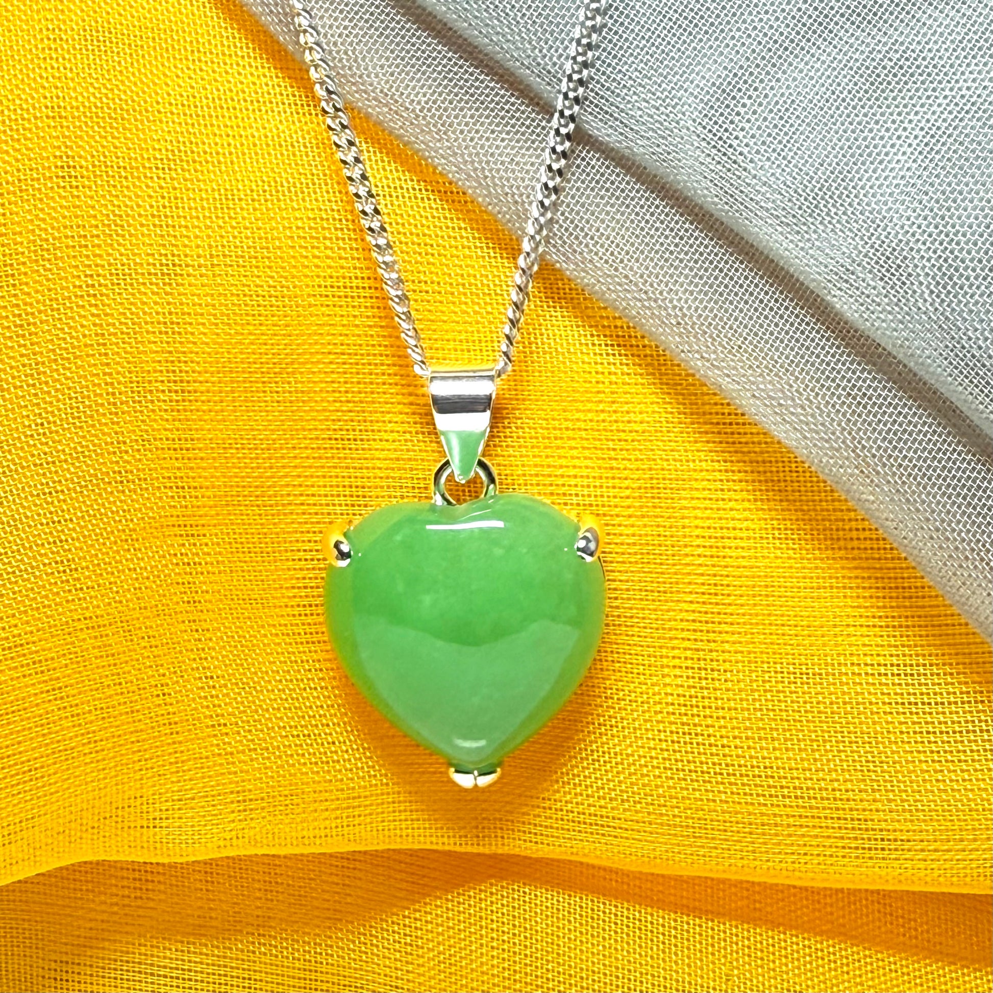 A real green jade necklace heart shaped sterling silver with chain included as well
