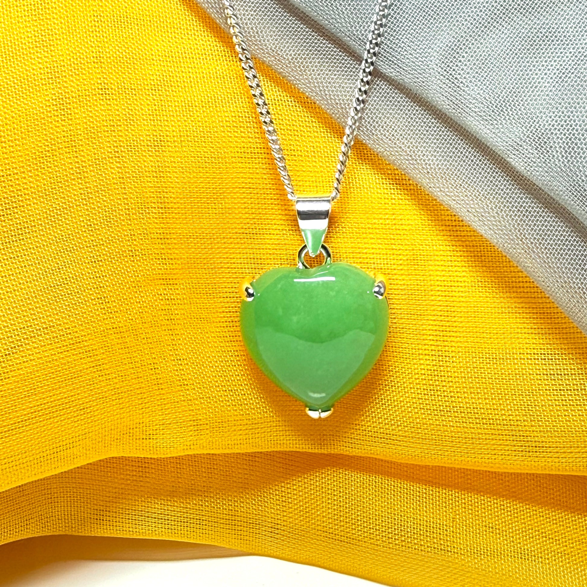 A real green jade necklace heart shaped sterling silver with chain included as well