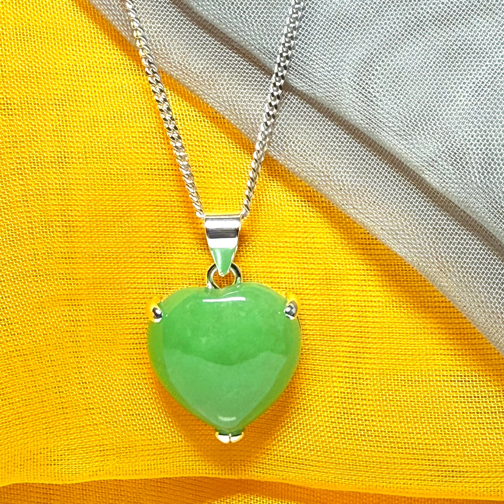 A real green jade necklace heart shaped sterling silver with chain included as well