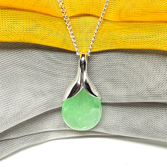 A real green jade necklace in a teardrop or pear shape, a traditional designed pendant