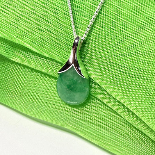 A real green jade necklace in a teardrop or pear shape, a traditional pendant