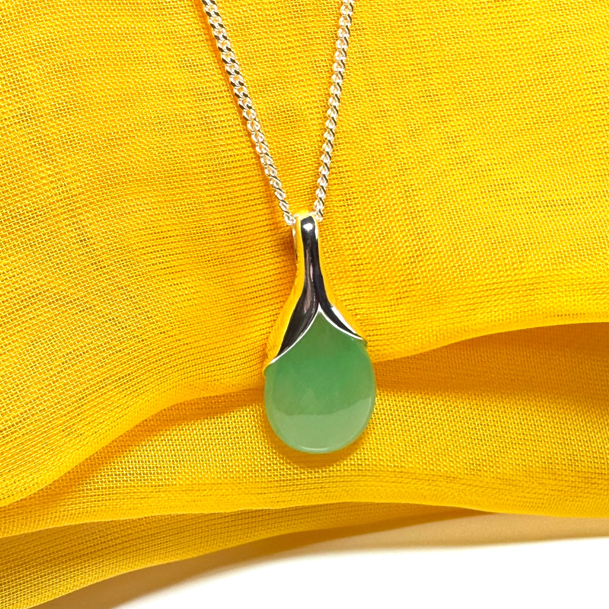 A real green jade necklace in a teardrop or pear shape