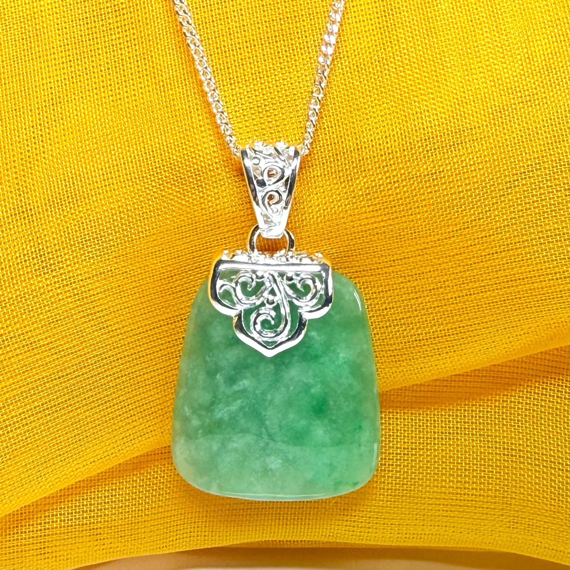 A real green jade necklace sterling silver large cushion shaped including a curb chain, beautiful